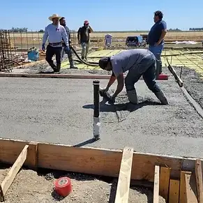 Workers finishing the concrete floor